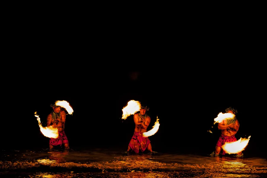 Polynesian dancers performing at night at an Oahu luau